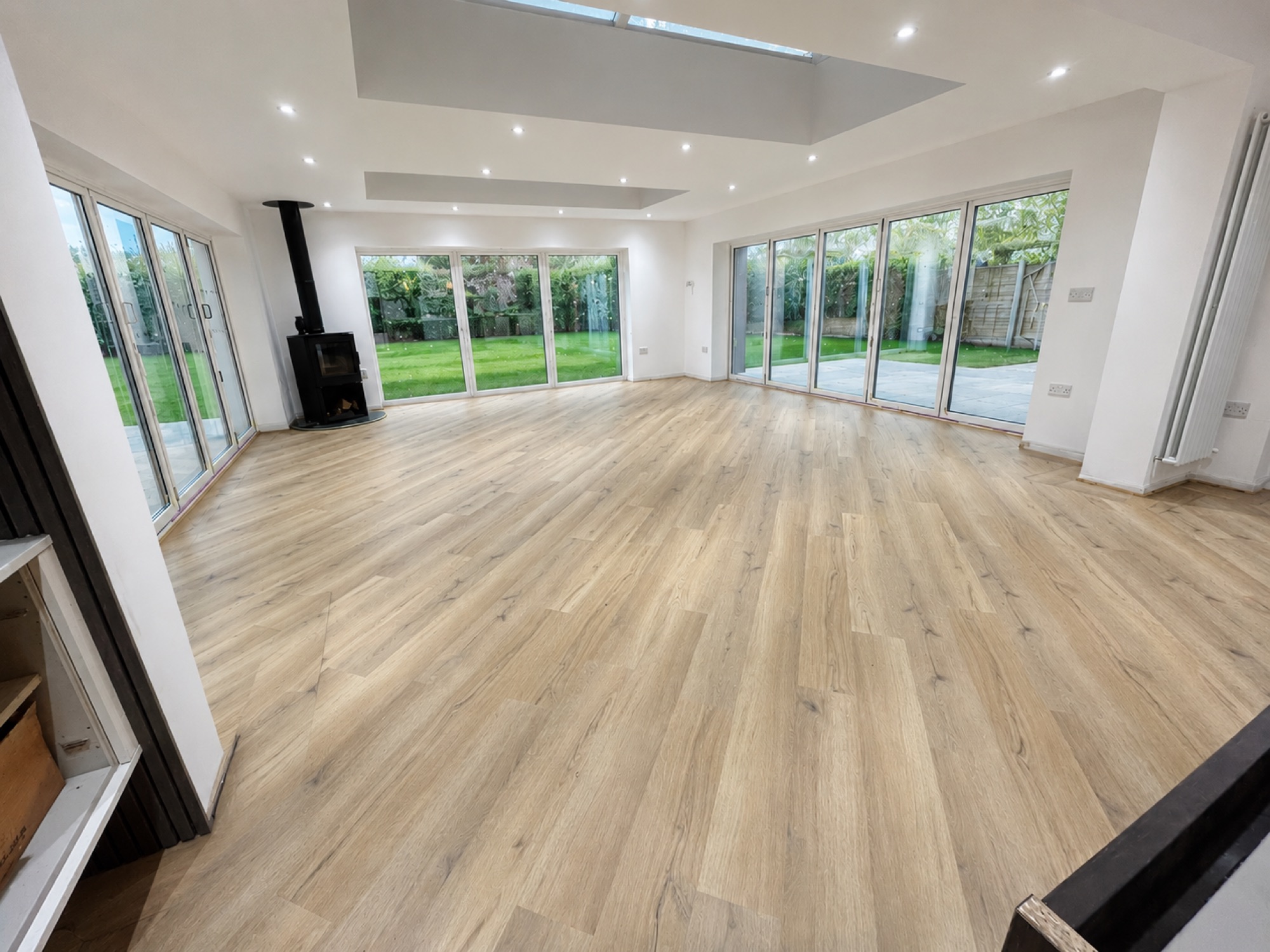 Light, open-plan room with a newly fitted light oak floor