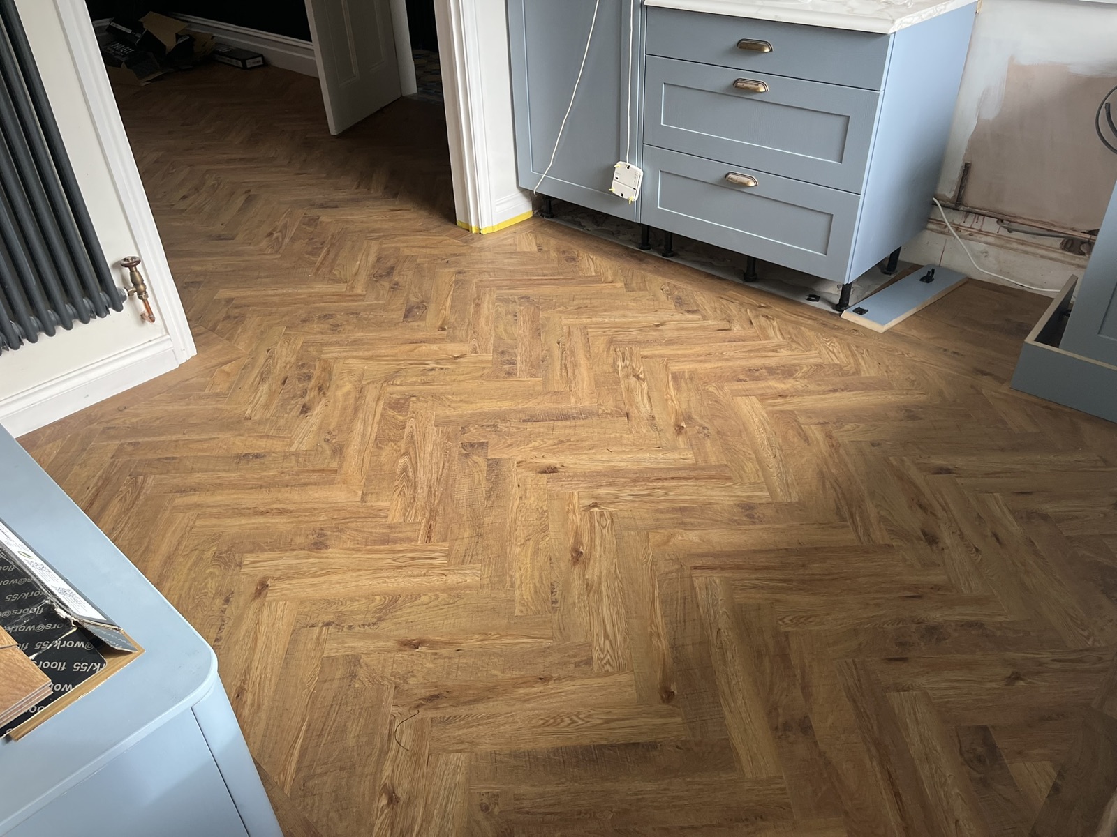 Herringbone LVT across an open-plan kitchen and dining room